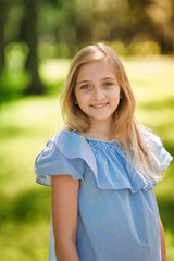 Fototapeta premium Portrait of a beautiful young girl in the park