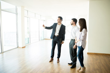 Real Estate Agent Showing New Apartment To Man And Woman