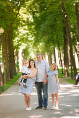 Fototapeta premium Happy family with two kids in the park