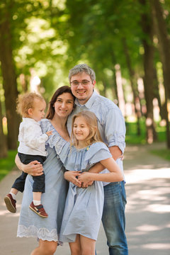 Happy family with two kids in the park