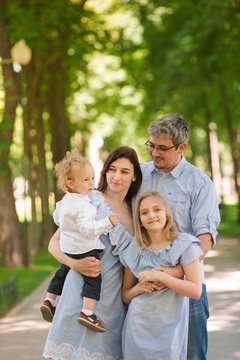 Happy family with two kids in the park