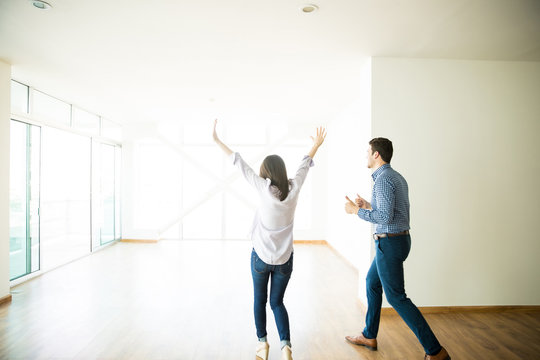 Excited Man And Woman Entering Into New Apartment