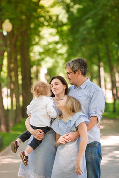 Happy family with two kids in the park