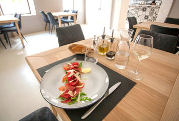 Meat dish on plate, tasty Carpaccio for hungry visitors of a restaurant