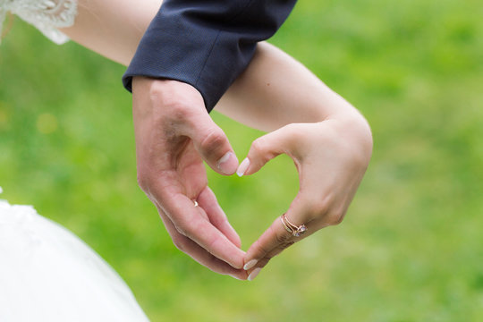 Wedding heart hands of newlywed couple