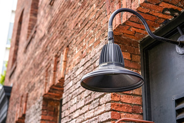 Wall of red brick and street lamp, San Francisco, USA