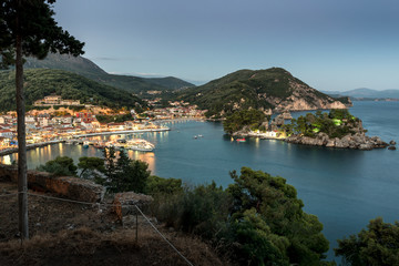 Fototapeta na wymiar Panoramic view of the resort town of Parga, the harbor, the beach and islets at sunset (region of Epirus, Greece)