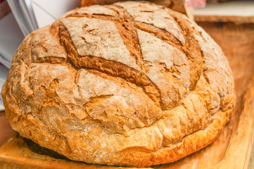 Baked bread close up on wooden background