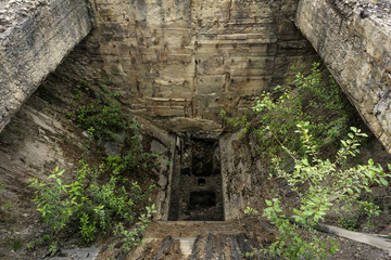dilapidated entrance bin of abandoned mine rock crusher
