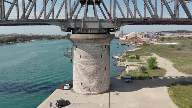Rail swing bridge at canal de Caronte. in France.  Pivoting moving bridge over French Chenal de Caronte in Pointe Paradis. Engineering example of classic turning overpass.