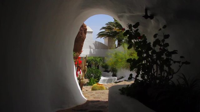 Woman walks through the Lagomar house museum going up the stairs