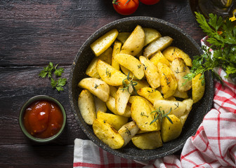 Baked potato with herbs top view.