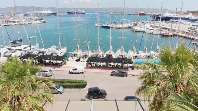 4K aerial footage of a marina in greece showing some yachts and shops