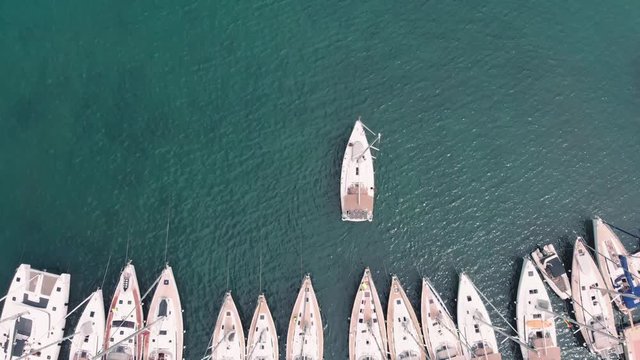 4K footage of a yacht leaving the harbor, starting a journey in greece