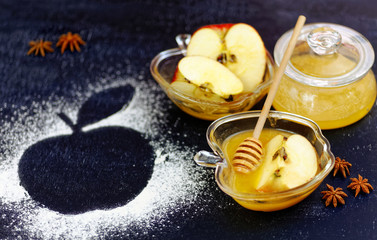 Apple an honey on chalkboard table. Traditional celebration food for the Jewish New Year. Concept of Jewish New Year Rosh Hashanah