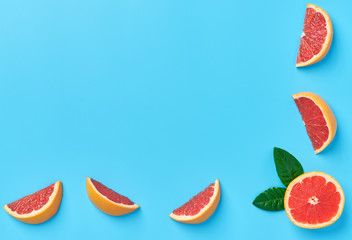 Ripe half of pink grapefruit on a blue background