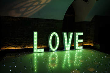 Illuminated Love sign in large letters at a wedding reception ready for the First Dance
