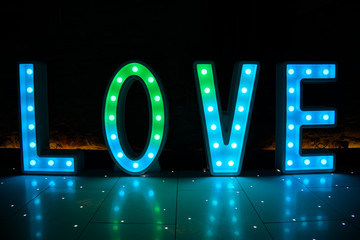 Illuminated Love sign in large letters at a wedding reception ready for the First Dance
