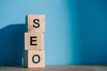 alphabet cubes with SEO word on blue background