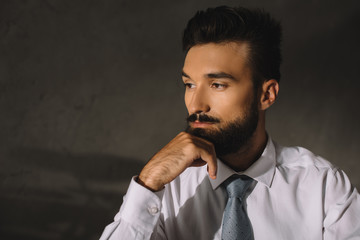 portrait of bearded pensive professional businessman