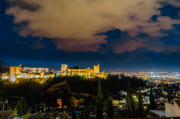 Night cityscape of Granada, Spain, with the Alhambra Palace in the background