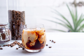 cold brew coffee with milk on white wooden table