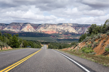 Empty road in front of a mountain in Zion National Park, utah, USA