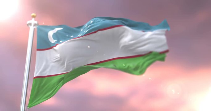 Uzbekistan flag waving at wind in slow at sunset, loop