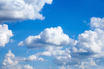 Naklejka na ściany i meble Cloudscape. Blue sky with large white clouds. Beautiful big clouds slowly float against the blue sky.