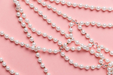 Flat lay of creative female jewelry on the colorful pink background with copy space. Top view