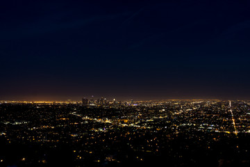 Fototapeta na wymiar View of the downtown Los Angeles skyline at night, from Griffith Observatory, in Griffith Park, Los Angeles, California.