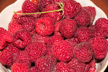 organic raspberries in a bowl . Raspberry fruit © elinkac