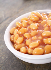 baked beans in tomato sauce in white  dish