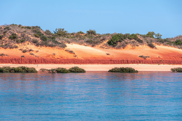 Broome, WA, Australia - November 29, 2009: Closeup of Horizontal line made by red dunes with some...