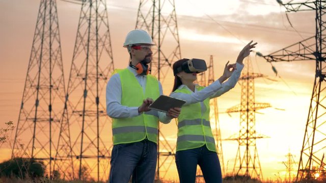 Team of Industrial Engineers Works near power line using 3D VR technology.
