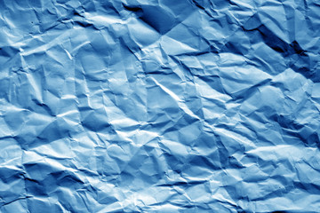 Crumpled sheet of paper in navy blue tone.