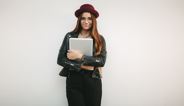 Portrait of a creative businesswoman holding laptop