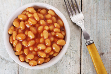 baked beans in tomato sauce in white  dish