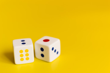 white dice on yellow background