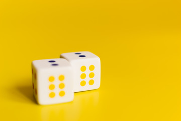 white dice on yellow background