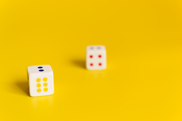 white dice on yellow background