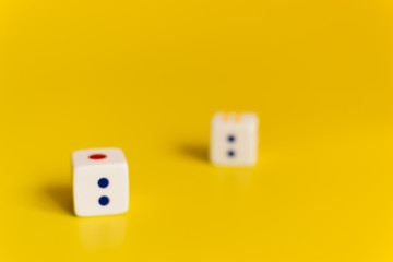 white dice on yellow background