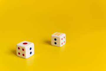 white dice on yellow background