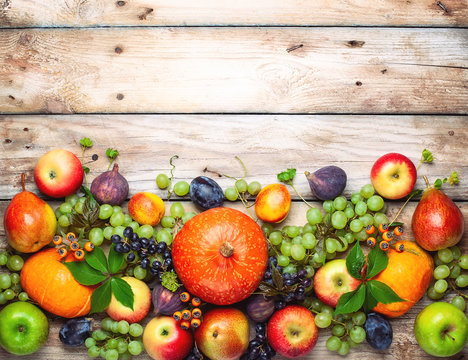 Thanksgiving background with autumn pumpkins, fruits and flowers