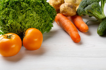 Include fresh organic vegetables on white wooden floor with copy space