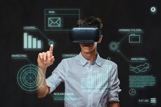 Technology concept. Teenager dressed in a white t-shirt using virtual reality glasses with graph charts, numbers, lines. 