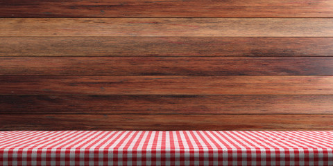 Table covered with red tablecloth on wooden wall background, copy space. 3d illustration