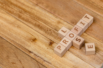 Wooden block stack business concept, profit and lose letters.