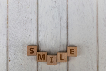 Wooden blocks on white wooden background.