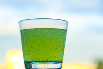 a bottle of lemonade and pieces of lemon with mint